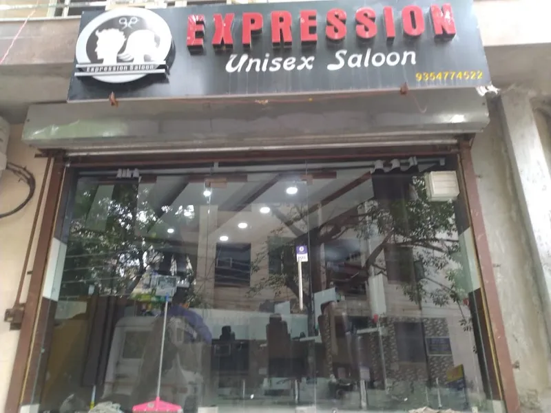 The exterior signage of Expression Unisex Salon on Vyapar Kendra Road.